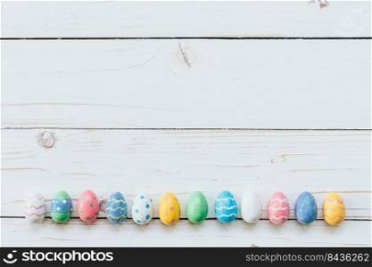Colorful eggs easter on white wood background with space for text.