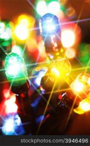 Colorful electric light bulbs close-up with glare