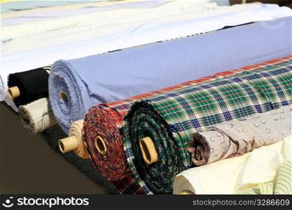 Colorful fabric rolls row in market shop vanishing perspective
