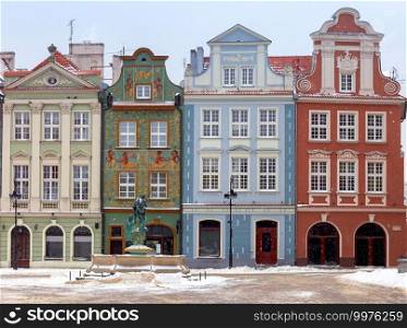 Colorful facades of medieval houses in the market square on a snowy winter day. Poznan Poland.. Poznan. Market square on a winter day.