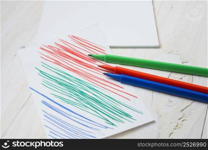 colorful felt tip pen paper with pen stroke white wooden table