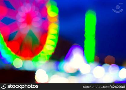 colorful ferrys wheel fairground night lights over blue sky