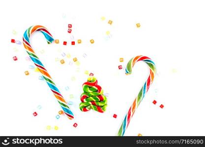 Colorful festive Lollipops and candy in fir form on white background selective focus.. Colorful festive Lollipops and candy in fir form on white background selective focus