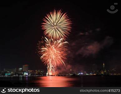 Colorful firework at Pattaya coast with cityscape background, Thailand