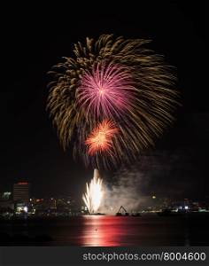 Colorful firework at Pattaya coast with cityscape background, Thailand