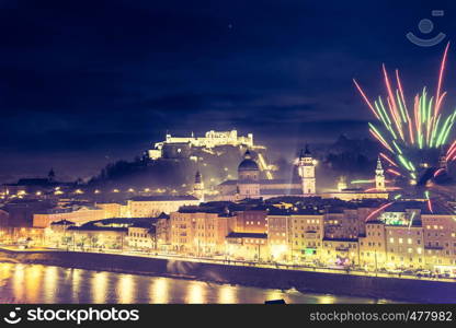 Colorful firework in the night: Old city of Salzburg and Festung Hohensalzburg at New Year's Eve. Magic