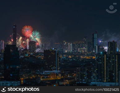 Colorful Firework with cityscape night light view of Bangkok skyline at twilight time. New Year celebration fireworks, Bangkok city,Thailand Fireworks light up to sky at Christmas   New Year festival with free space for text. No focus, specifically.