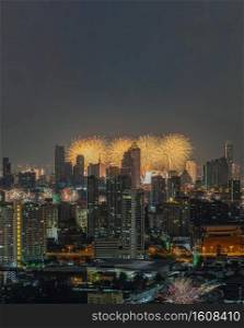 Colorful Firework with cityscape night light view of Bangkok skyline at twilight time. New Year celebration fireworks, Bangkok city,Thailand Fireworks light up to sky at Christmas & New Year festival with free space for text. No focus, specifically.