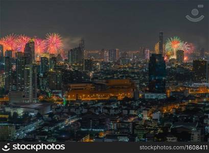 Colorful Firework with cityscape night light view of Bangkok skyline at twilight time. New Year celebration fireworks, Bangkok city,Thailand Fireworks light up to sky at Christmas   New Year festival with free space for text. No focus, specifically.