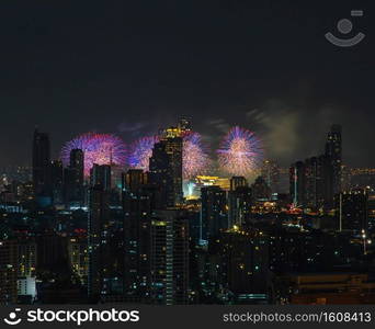 Colorful Firework with cityscape night light view of Bangkok skyline at twilight time. New Year celebration fireworks, Bangkok city,Thailand Fireworks light up to sky at Christmas   New Year festival with free space for text. No focus, specifically.