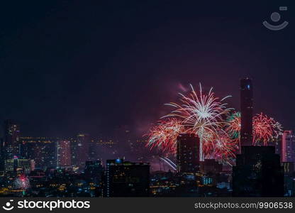 Colorful Firework with cityscape night light view of Bangkok skyline at twilight time. New Year celebration fireworks, Bangkok city,Thailand Fireworks light up to sky at Christmas   New Year festival with free space for text. No focus, specifically.