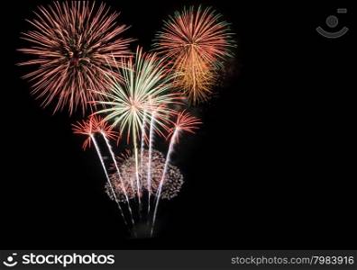 Colorful fireworks explode in the night sky with copy space. New year concept.