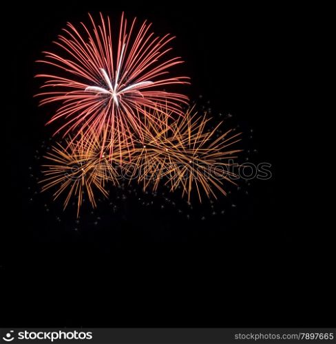 Colorful fireworks exploding in the night sky with copy space