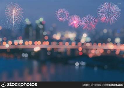 Colorful fireworks on twilight sky background with blurred city lights bokeh illuminate at night