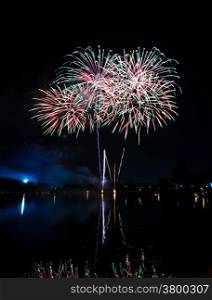 Colorful fireworks with reflection on lake
