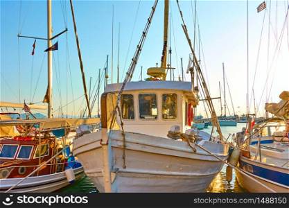 Colorful fishing boats in the harbour in the evening, Aegina Island, Greece