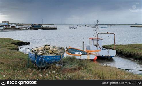 Colorful fishing boats on the river Alde at Aldeburgh, Suffolk, UK