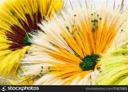 Colorful flowers made of ears of wheat or rye, concept of seasonal harvesting decorations. Colorful flowers made of ears of wheat or rye, seasonal harvesting decorations concept