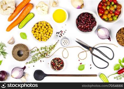 Colorful food ingredients on white background. Bio Healthy food herbs and spices for health cooking. Organic cooking ingredients over white. Diet or vegetarian food concept. Top view copy space.