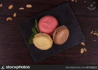 Colorful french macarons . Colorful french macarons on wooden background