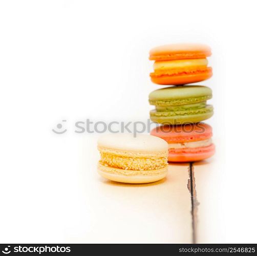 colorful french macaroons over a white rustic wood table