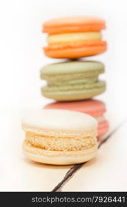 colorful french macaroons over a white rustic wood table