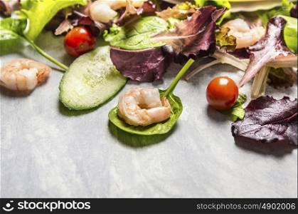 Colorful fresh salad with cucumber and shrimps, close up, place for text