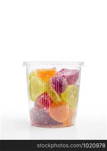 Colorful fruit jelly in foam jar, on white background