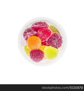 Colorful fruit jelly in open foam jar, on white background. Top view.
