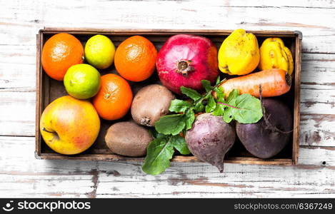 Colorful fruits and vegetables. Box with apple, tangerine, lime and pomegranate.Healthy lifestyle concept