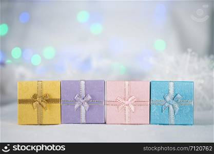 Colorful gift boxes on the white fur, bokeh background, with copy space for season greeting, Merry Christmas or Happy New Year.AF point selection,blurred.