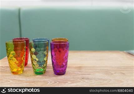 colorful glass on wood table in cafe restaurant