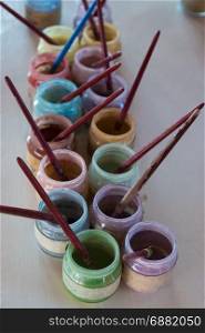 Colorful Glass Paint Jars in Line with Artist Brushes