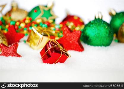 Colorful glitter christmas balls and decoration on snow