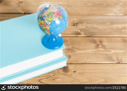 colorful globe blue books wooden table