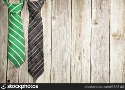 Colorful green and brown necktie on wooden background texture, National men&rsquo;s Day, Father Day design with copy space Space for text. Colorful green and brown necktie on wooden background texture, National men&rsquo;s Day, Father Day design with copy space
