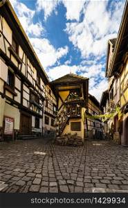 colorful half-timbered houses in the narrow streets of Eguisheim, Alsace Region, France