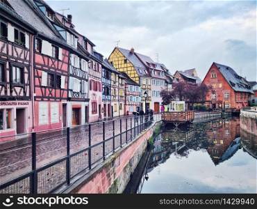 colorful halftimbered houses along a cobblestone road in the medieval town of Colmar, Alsace Region, France