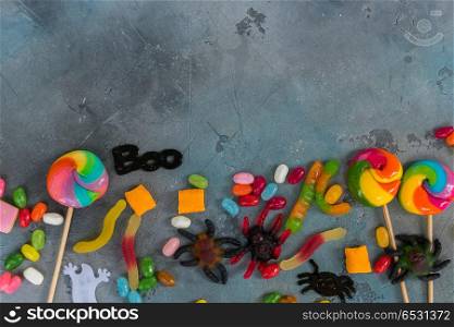 Colorful halloween candies on stone. Trick and treat - colorful halloween candies on stone with copy space