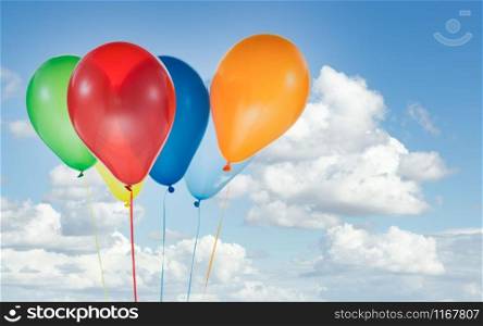 Colorful helium balloons for birthday and celebrations isolated at blue sky with white clouds and copy space for free text. Colorful balloons for birthday and celebrations isolated at blue sky