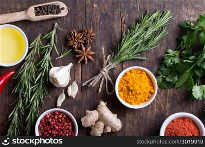 Colorful herbs and spices selection. Aromatic ingredients on wood table