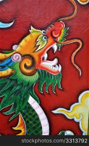 Colorful historic paintings of dragon on the red door