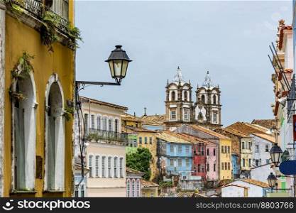 Colorful historical colonial houses facades and antique church tower in baroque and colonial style in the famous Pelourinho district of Salvador, Bahia. Colorful historical colonial houses and church tower in baroque and colonial style