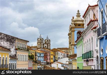 Colorful historical colonial houses facades and antique church towers in baroque and colonial style in the famous Pelourinho district of Salvador, Bahia. Colorful historical colonial houses facades and church towers in baroque and colonial style