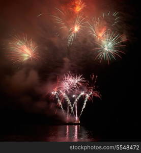 Colorful holiday fireworks on the black sky background.