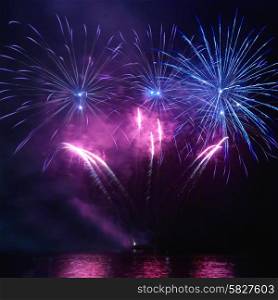 Colorful holiday fireworks on the black sky background
