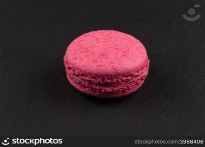 Colorful homemade chocolate macaroon on a dark background
