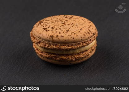 Colorful homemade chocolate macaroon on a dark background