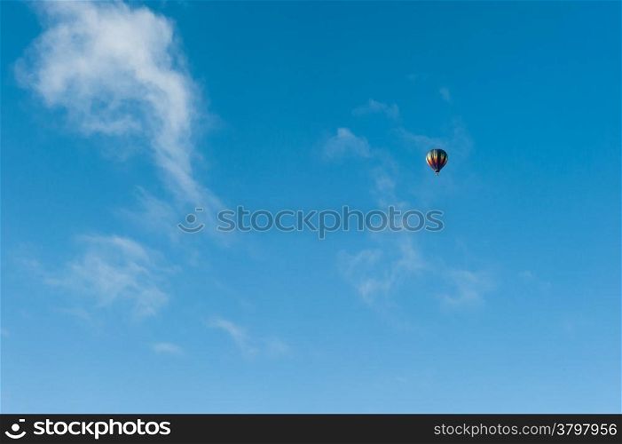 Colorful hot air balloon flying in the blue sky. Fun and happiness. A relaxing and beautiful flying experience.