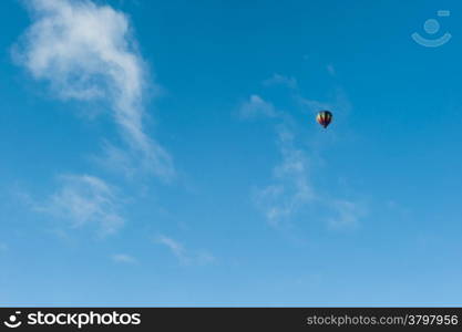 Colorful hot air balloon flying in the blue sky. Fun and happiness. A relaxing and beautiful flying experience.